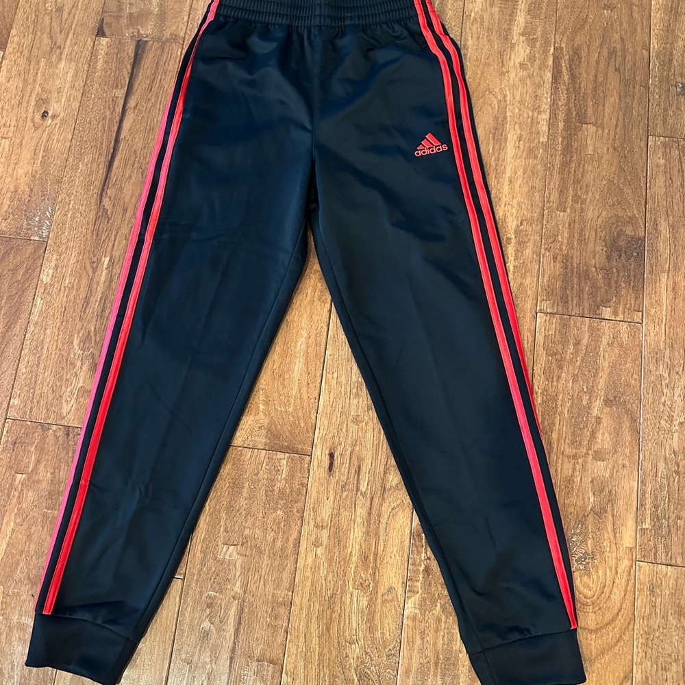 Like new boys Adidas joggers black with red side stripes size 10-12.